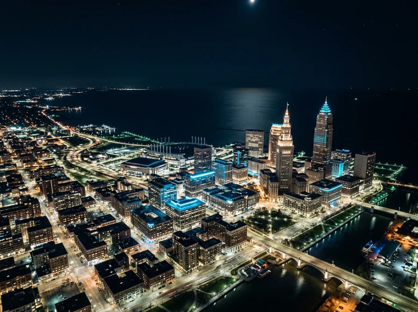 Cleveland skyline at night above Lake Erie
